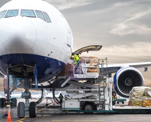 Side view of a plane being loaded with cargo