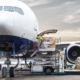 Side view of a plane being loaded with cargo